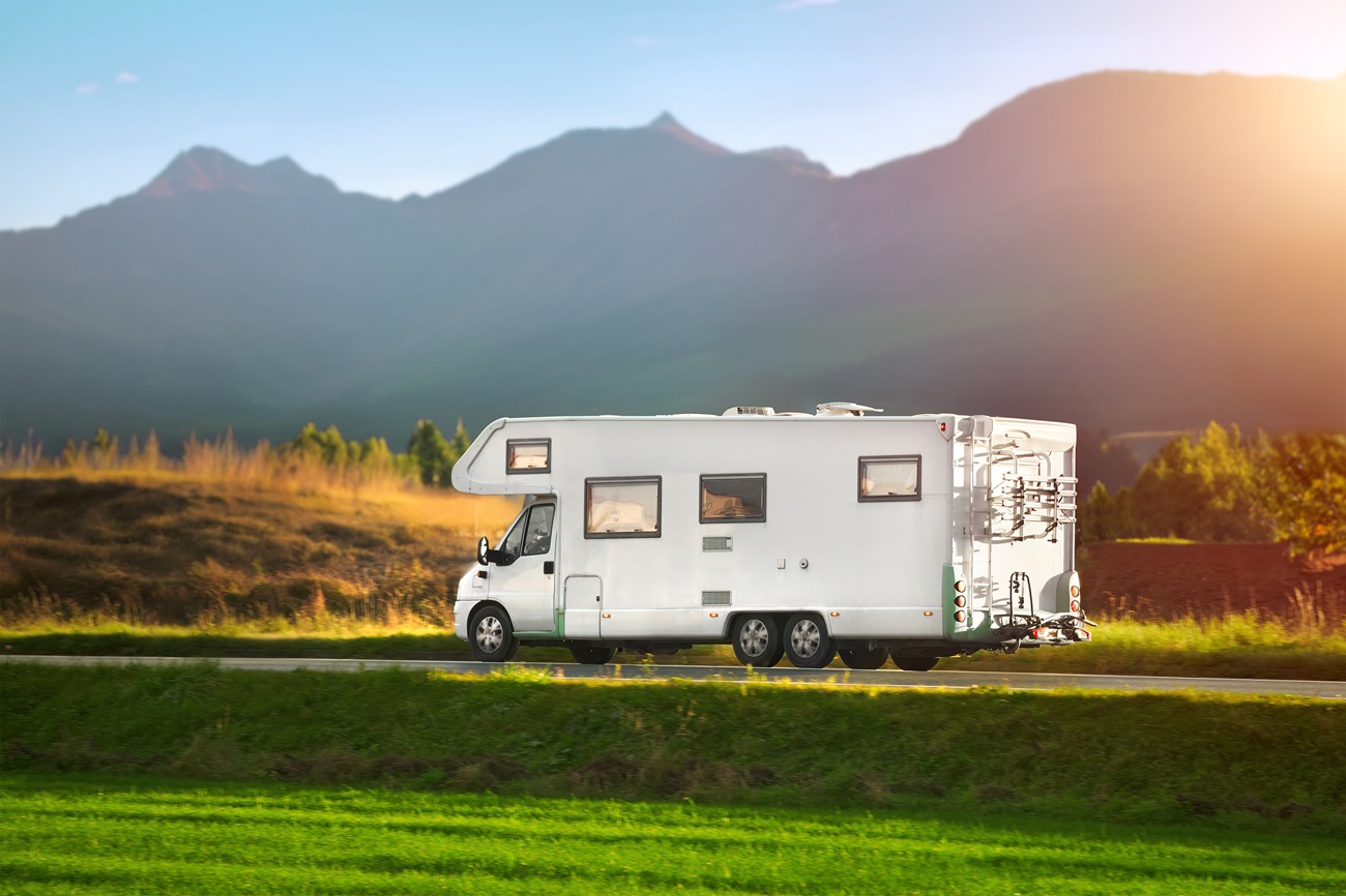 Rv Motorhome Camper Van On The Highway With Bike Rack. Travel Vacation Adventure. Tourists In Rental Campervan. Tourism In Motorhome Rv Motorhome Camper Van On The Highway With Bike Rack. Travel Vacation Adventure. Tourists In Rental Campervan. Tourism In Motorhome