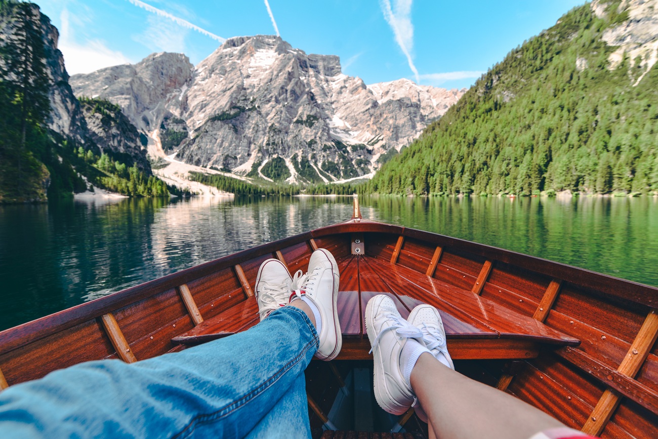 Couple Resting On Boat At Mountain Lake Couple Resting On Boat At Mountain Lake